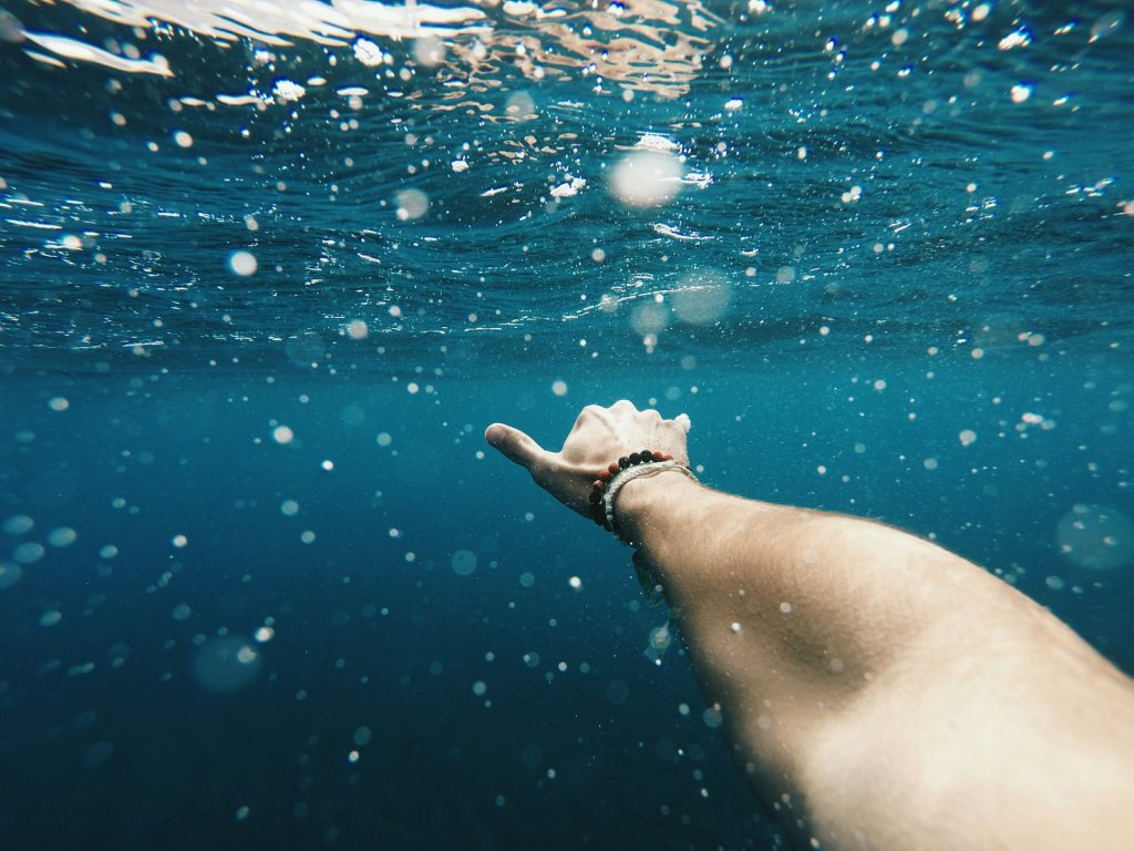 Diver filming underwater with a camera