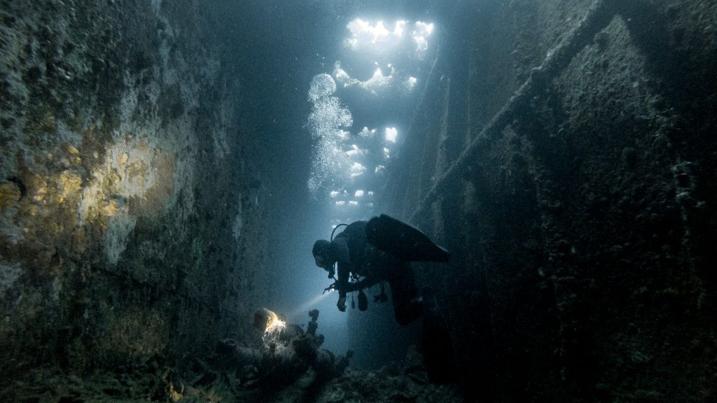 Diver underwater with regulator in mouth