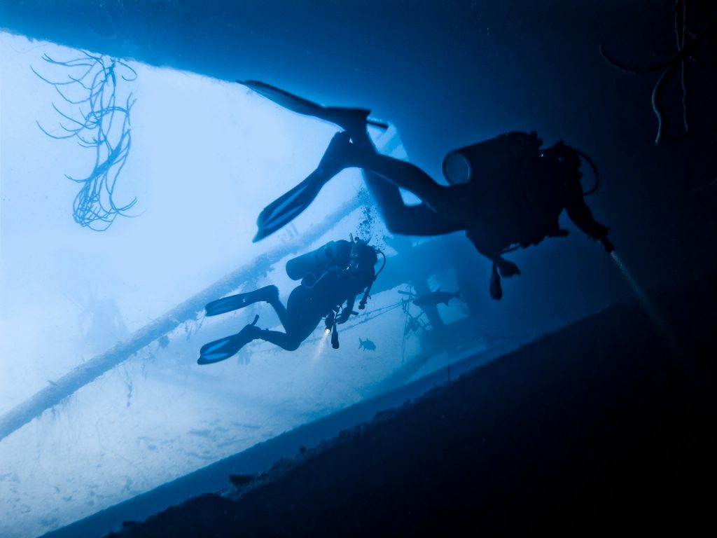 Two scuba divers swimming together